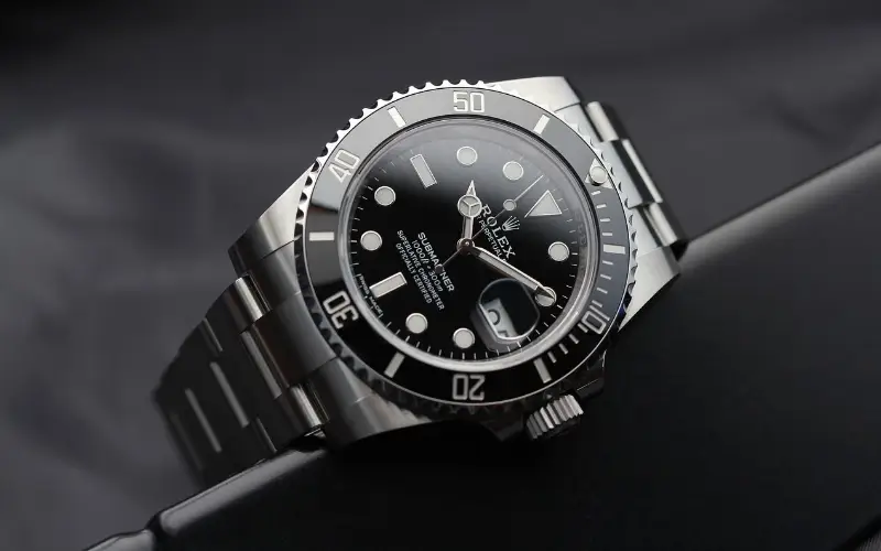 a magnificent black Rolex submariner on a dark background